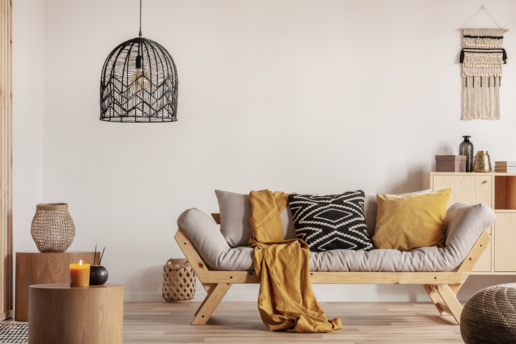 Chic black chandelier above couch in contemporary living room